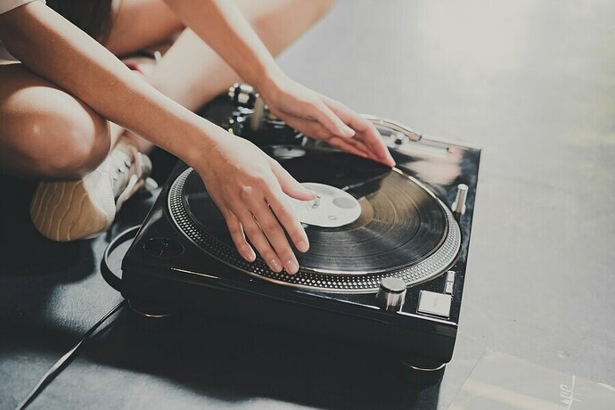 a-young-woman-sits-on-the-floor-and-explores-vinyl-records-puts-them-on-a-retro-player_158155-1465.jpg.e4123d4db5703467e277758d1abba64c.jpg